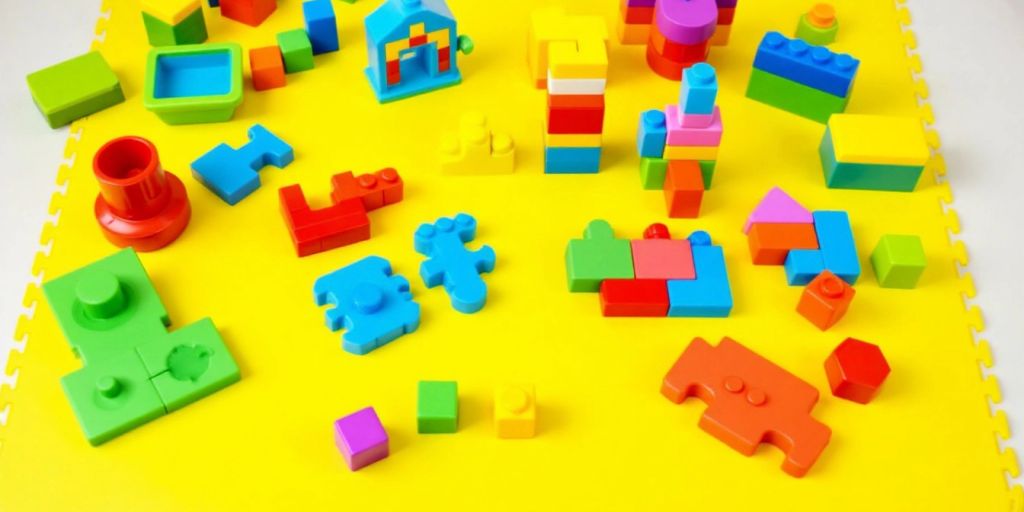 Colorful educational toys for kids on a play mat.