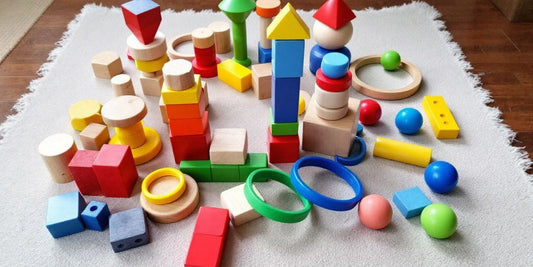 Montessori toys for toddlers on a play mat.